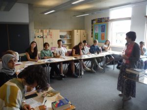 egugee children in class at summer school with English teacher