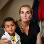 Aimee James and her son Isaac are waiting for school transport to be arranged