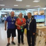Ron and Anne-Marie Carlin of Surrey Stands With Ukraine stand with Mayor Clive Woodbridge of Epsom and Ewell in the Ashley Centre