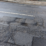 Pothole in Woodcote Road Epsom