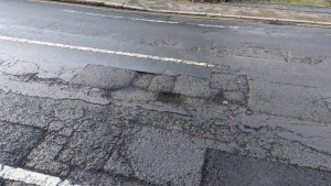 Pothole in Woodcote Road Epsom