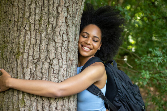 Young person hugging a tree