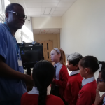Dr Osagie and Ewell Grove school children with ultra sound