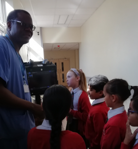 Dr Osagie and Ewell Grove school children with ultra sound