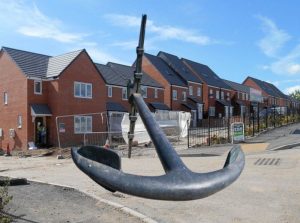New housing with an big anchor in foreground
