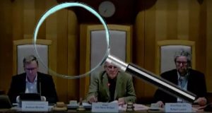 Meeting of audit and scrutiny with magnifying glass