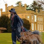 Nonsuch Mansion house and multiple dog walker
