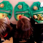 Three children with school dinners