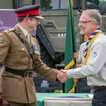 Scout leader shakes hand with army officer