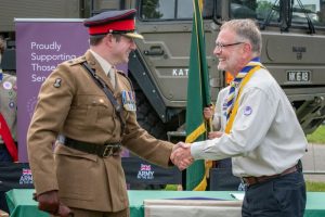 Scout leader shakes hand with army officer