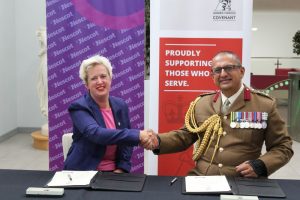 Julie Kapsalis, Principal and CEO, Nescot and Brigadier Ben Banerjee, Head Army Medical Reserve, Army HQ, sign the Armed Forces Covenant at Nescot.