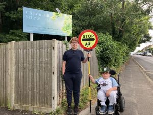Students Mckenzi, 15, and Erctunc, 17, holding the school-bought lollipop sign. (Credit: Emily Dalton/LDRS)