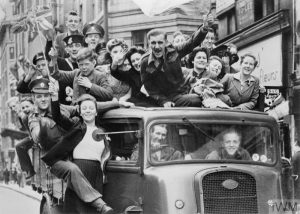 VE DAY CELEBRATIONS IN LONDON, 8 MAY 1945 (HU 41808) A truck of revellers passing through the Strand, London, 8 May 1945. Copyright: © IWM. Original Source: http://www.iwm.org.uk/collections/item/object/205021981