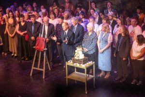 The Duke of Edinburgh addresses the audience, in front of the assembled concert company, before unveiling a commemorative plaque