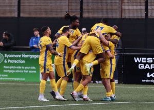 Epsom and Ewell FC players celebrate an away win