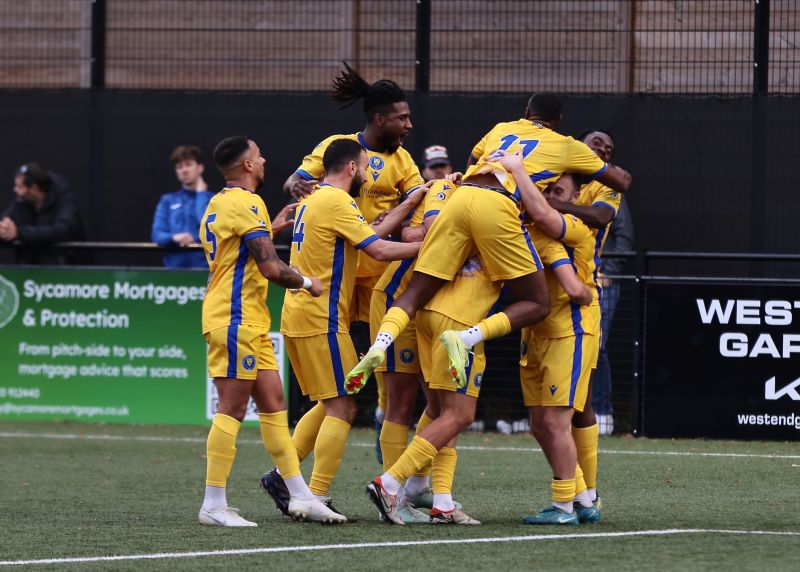 Epsom and Ewell FC players celebrate an away win