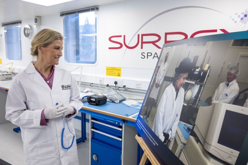 HRH The Duchess of Edinburgh looking at a picture of Her Late Majesty Queen Elizabeth II at the University of Surrey. Credit Surrey University