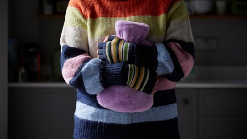 Person holding a water bottle.