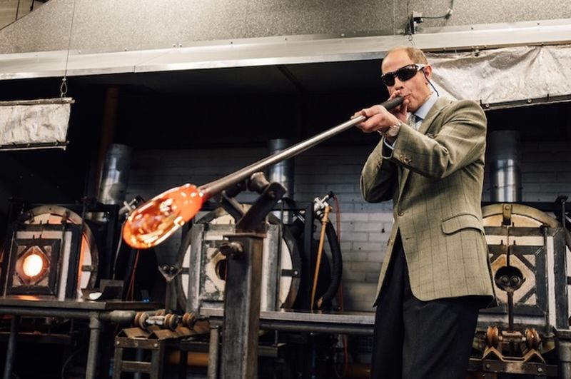 Duke of Edinburgh blows glass at Epsom's UCA workshop