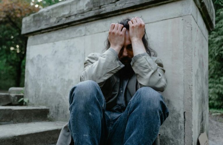 Poor man sitting down outside. Image: Mart Production