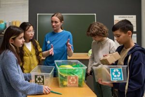 Teacher with children sorting waste