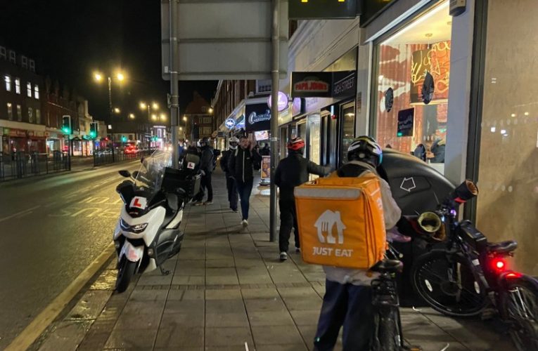 Delivery mopeds in Epsom High Street