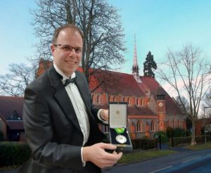 Karl Nicholas against the background of St Mary's Church