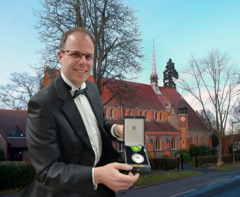 Karl Nicholas against the background of St Mary's Church