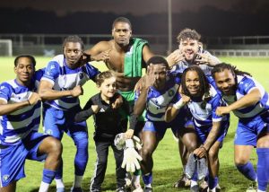 Epsom and Ewell FC's top line with young boy mascot