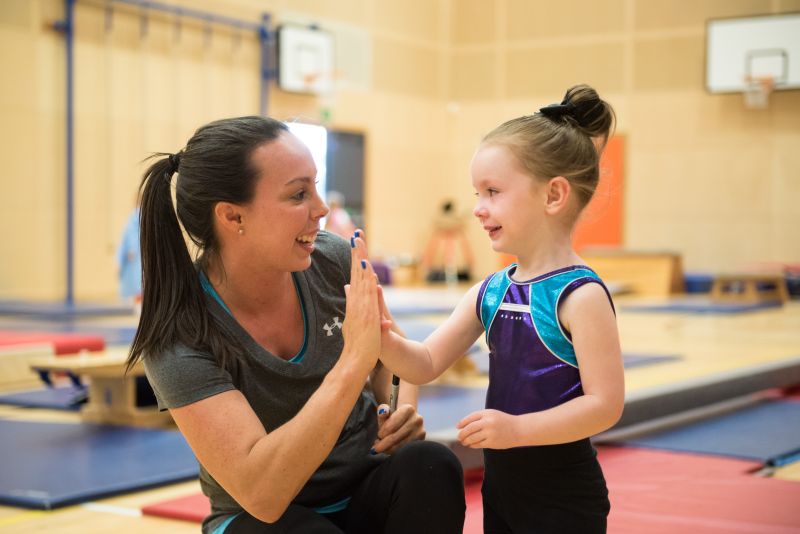 Beth Tweddle with child in gym